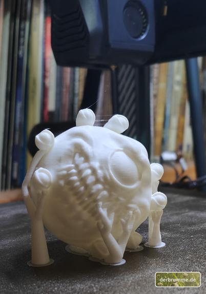 Eine fertig 3d-gedruckte Christbaumkugel in Form eines Betrachters.