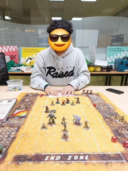 Student playing blood bowl looking relaxed but all you see is a smiey