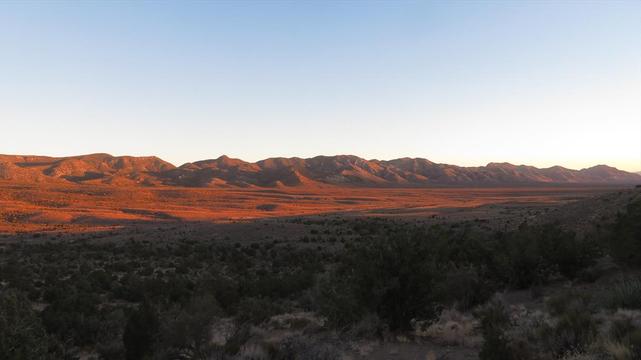 Wide valley, orange in sunset glow.