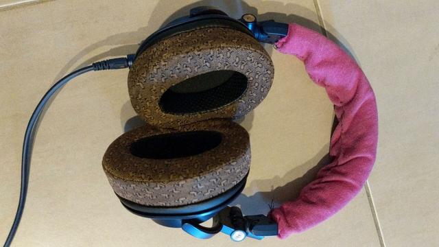 set of Audio Technica ATH-M50x headphones with patterned brown fabric replacement earpads. The headband also replaced with hand sticked pink cloth.