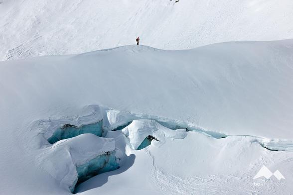 skier above glacier ice