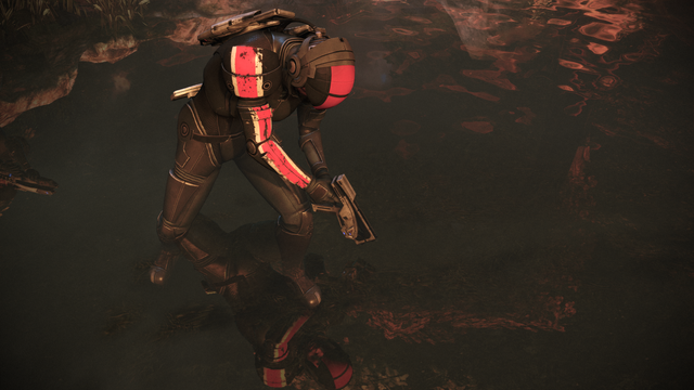 Print do jogo Mass Effect, em sua versão remasterizada presente na coletânea Legendary Edition para PC de 2021. O local é Eden Prime, os personagens estão com armaduras / trajes espaciais com capacete, andando num riacho. A imagem é mais nítida, as texturas são mais detalhadas e há um reflexo na água do personagem Sheppard (e parte do reflexo de outro personagem que não aparece no frame, mais à esquerda).