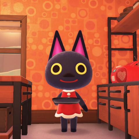 Animal Crossing: New Horizons screenshot. Image shows Kiki (black cat with yellow eyes) wearing a red Santa dress in front of a stove while holding a cooking pan.