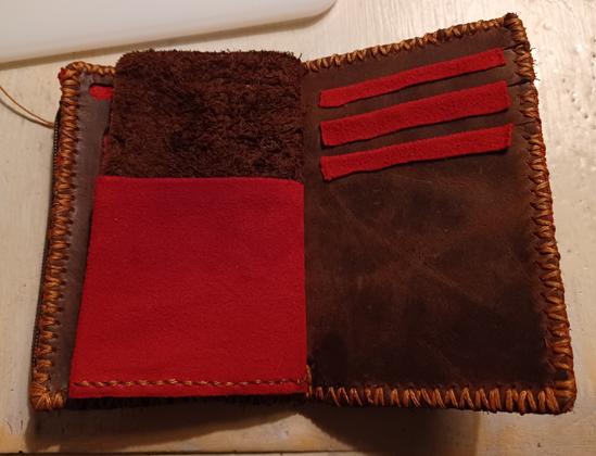 A red and brown wallet interior with four card slots.