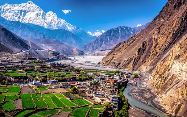 I started in the Annapurna area acclimatizing three days at 2800 meters. On the second day I walked from Jomsom to Kagbeni, discovering there was a big Hindu celebration going on  almost resulting in not finding a ho(s)tel. 

Next morning the whole valley was filled with pilgrims who were washing themselves in a very cold river (Kali Gandaki) and who were enjoying the company of friends and family. Other people were heading in the direction of Muktinath, and all the roads would fill up with buses, taxis and cars, going the way up.

In the meantime I did a stroll a little up a mountain to have this wonderful view of the valley. The Nilgiri mountain, that is part of the Annapurna massive  in the background.