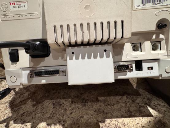 The back of an Alextel terminal with a series of ports: DB25, DB9, RJ11 in and out.