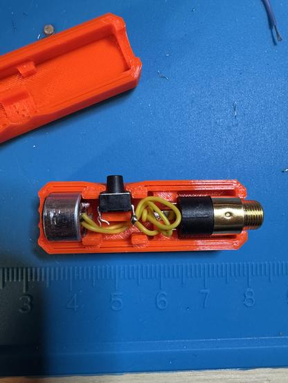 Mic element, switch, wires and jack being assembled in the housing.