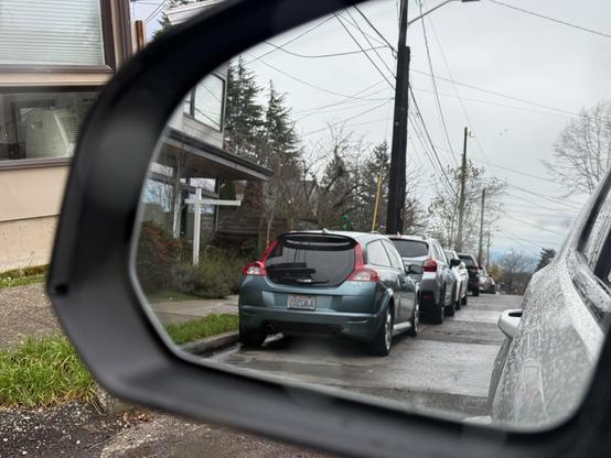 A photograph of a Volvo C30 as reflected in the post author’s rear view mirror.
