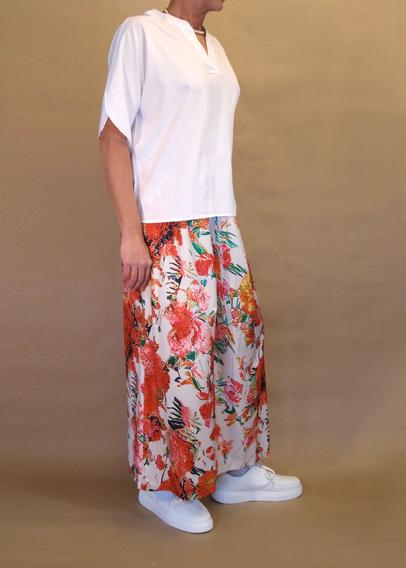 I’m posing in my floral pattern skirt pants and a white v-neck short sleeved blouse and chunky white sneakers with kawaii ankle socks. I’m also wearing silver pearl necklace and armband. Seen my front right as I’m a bit slumped.