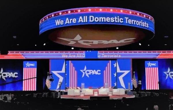 The stage from one of the recent CPAC nazi meetings where they had “We Are All Domestic Terrorists” in lights above the stage.