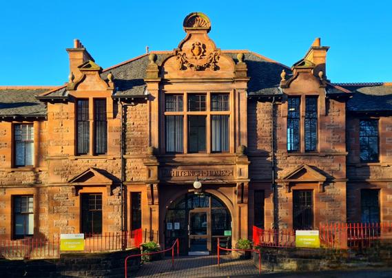 The entrance to a Scots Renaissance style red sandstone building.