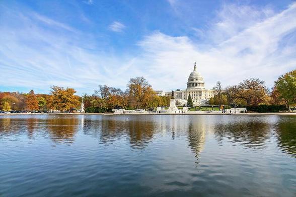 View of the U.S. Capitol and Reflecting Pool in Washington D.C. during autumn, showcasing the grandeur and beauty of this iconic landmark.
