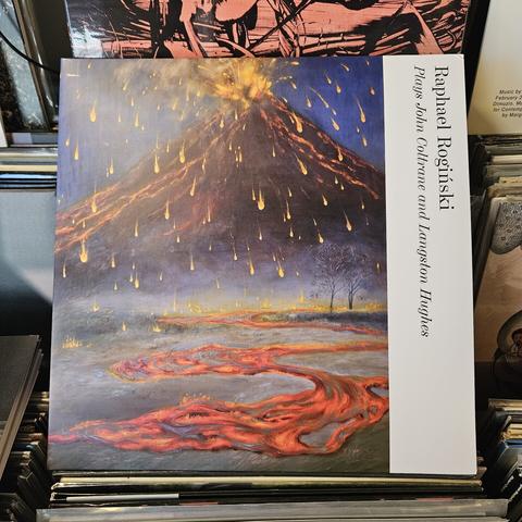 Album cover features a colorful illustration of a volcano erupting. There are lots of glowing yellow bits of lava raining from the air, and a river of orange lava wends toward the viewer.