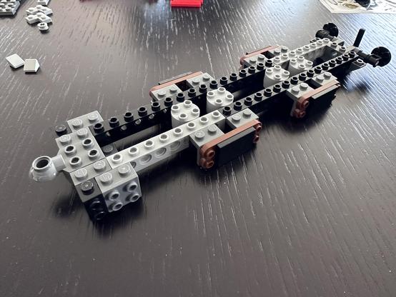 The base under structure for the coal carriage. Little more than a skeleton of black, grey, and brown Lego pieces.