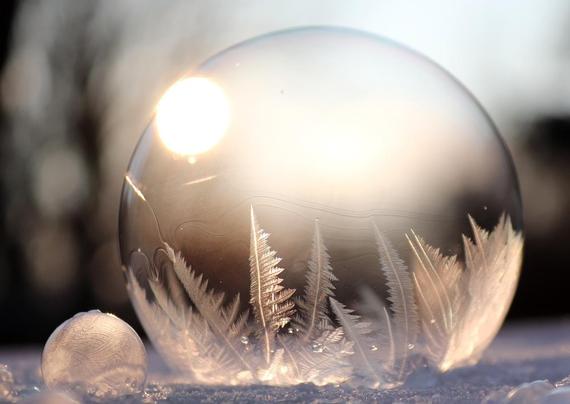 Sunlight shines through a soap bubble that encompasses frost crystals,  photograph courtesy of birgl via Pixabay