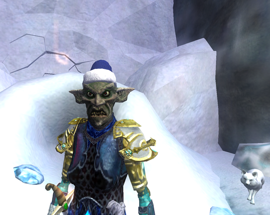 Screenshot from Everquest 2. A green troll with large spiky teeth and red eyes is standing in an ice cave wearing a royal blue Santa hat, glowing blue and gold armour. He has his arctic wolf pet standing beside him in the distance to the right.