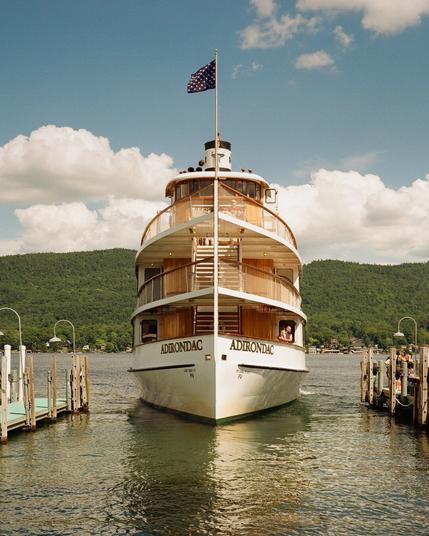 The cruise ship Adirondack shot from a head-on perspective, slowly docking at the harbor in Lake George, New York.