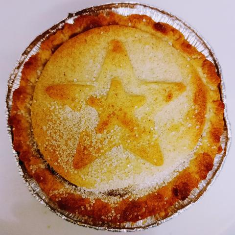 Photo of a cheap mince pie, one from a box of six for £1 from my  local shop.

This mince pie has a somewhat over baked pastry, with a relief star shape in the centre.