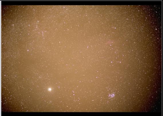 Original stack of exposures shows a brown sky and strong vignetting in the corners. If you try to push contrast now, in order to show faint details, the corners will go full black and the brown sky will overwhelm faint features.

We need to 'flatten' the sky and neutralize its color...