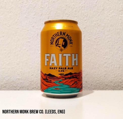 An orange can with a hilly landscape in red and a blue river flowing away into the distance.