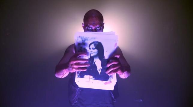 Shayan (Trivax) holding a photo of Mahsa Amini.