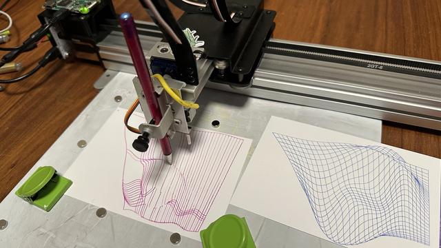 plotter with pink gel pen drawing a mathematical surface