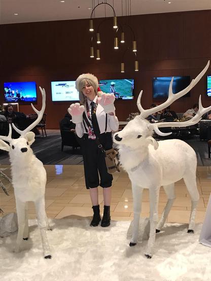 Atsushi Nakajima cosplayer standing between two reindeers at a Christmas display.