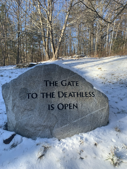 A rock engraved with “The Gate to the Deathless is Open.”