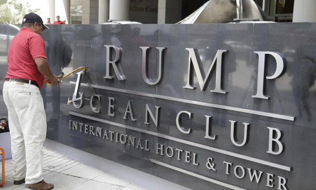 Worker removes the name Trump from Panama Ocean Club Intl Hotel.