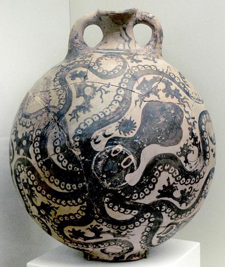A round clay flask from Minoan Crete. It is decorated in black with various sea creatures. Most of the body of the vessel is taken up by one large octopus with wide eyes and twisting arms.