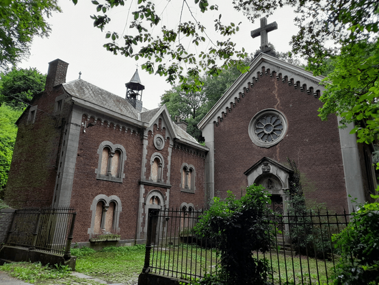 A deserted abbey in the forest. The windows are boarded up and the picture is quite dark.