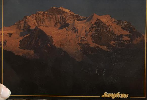 Postcard showing tall mountains