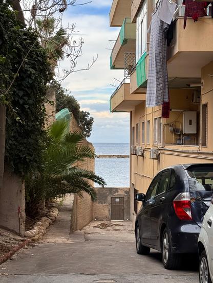 A sea view with a building and greens in Siracusa, Sicily
