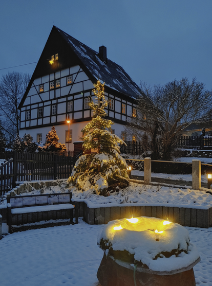 Parish house of my former home town. A big half-timbered house surrounded by trees. Every window is decorated with lights, also the large fir in front of it.