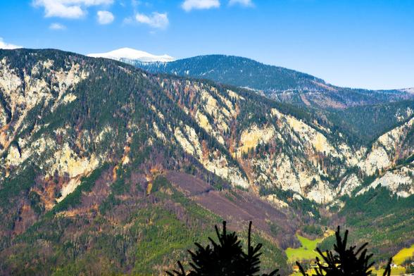The top of the schneeberg behind other mountains, lower austria