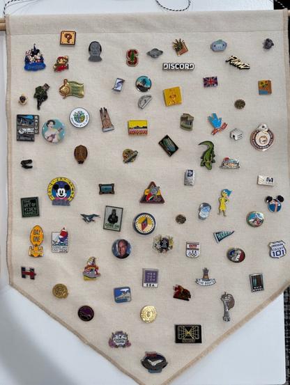 Dozens more pins arranged haphazardly on another off white cloth banner.
