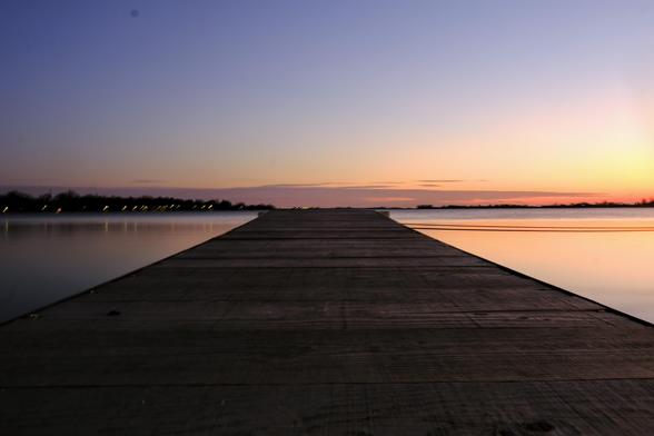 Pier onto the lake in sunset