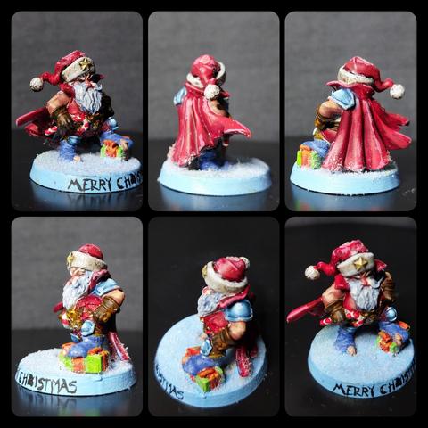 Captain Christmas, the Christmas halfling, apparently a blood bowl Star Player because he's got the kneecaps and shoulder pad but also a nice red cape and Santa hat with golden Star on the white fur brim. This specimen is positioned on a snowy base and wearing socks which have the big toes sticking out through holes; he's got his left foot poised on what looks to be a hero rock but is definitely a Christmas gift. In his right hand he's holding a candy cane which is probably some sort of a magical weapon