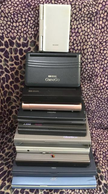 a stack of palmtop computers from thick to thin in the shape of a tree, including atari portfolio, libretto and more