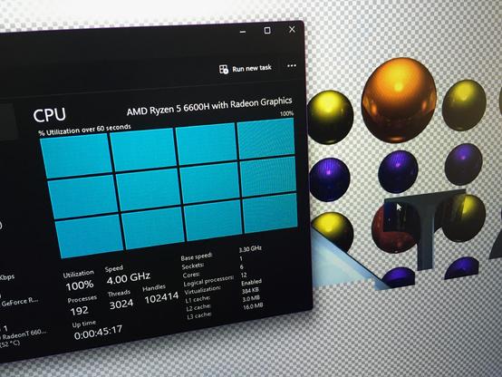 picture of windows with 12 logical processors at 100% with povray rendering spheres behind it