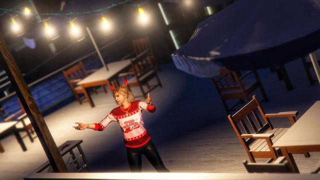 A screenshot I took in the video game GTA Online using the Rockstar Editor. It shows my second character (female) wearing the festive annual Christmas outfit with some decorative Christmas lights in the background.