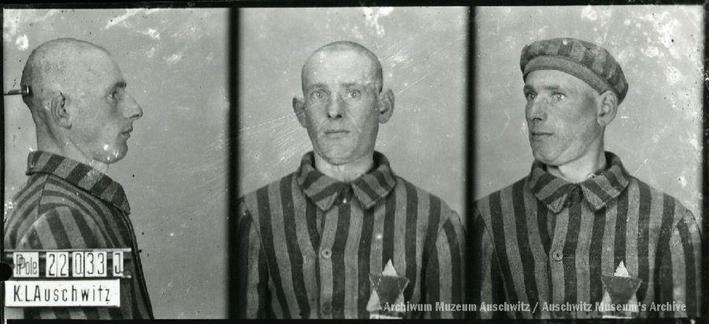 A mugshot registration photograph from Auschwitz. A man with a shaved head wearing a striped uniform photographed in three positions (profile and front with bare head and a photo with a slightly turned head with a hat on). The prisoner number is visible on a marking board on the left.