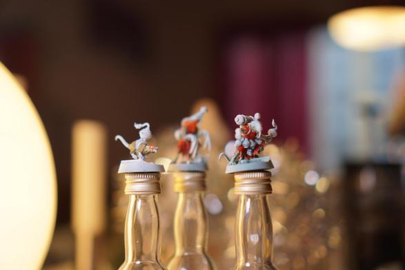 Three minature sculpts of humanoid rats. Mostly primed white, but with some colour on them. Slightly differently focused than the other picture.