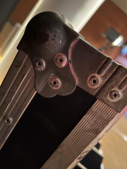 A metal thingy on the corner of a box that kinda looks like a dog