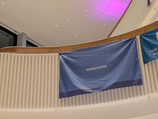 Windows XP welcome login screen in flag format hanging over a balcony