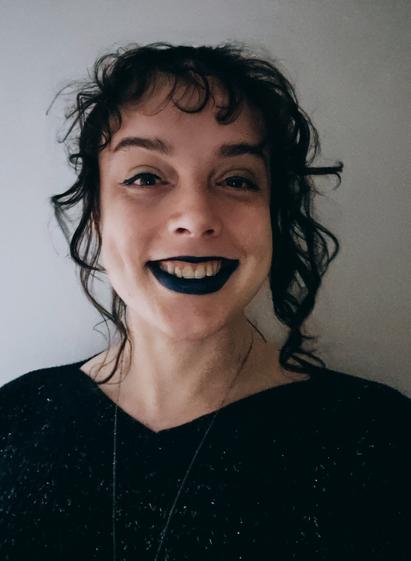 stel smiling really really big in dark lipstick with her hair tied up messy spilling curls