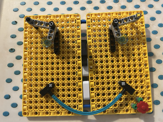 Face made of 2 yellow Lego panels, grey eyebrows & bendy blue mouth