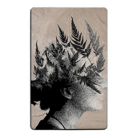A striking laser-etched design on a black anodized aluminum card. The front depicts a surreal composition: the silhouette of a human profile blends seamlessly with an intricate pattern of ferns, as if the foliage is growing from their thoughts. The background is textured with organic swirls resembling woodgrain, reinforcing themes of nature and mind intertwining. This visual allegory suggests the mystery of thought, creativity, and connection to the natural world—perhaps hinting at how one's inner consciousness mirrors the complexities of earth and sky.