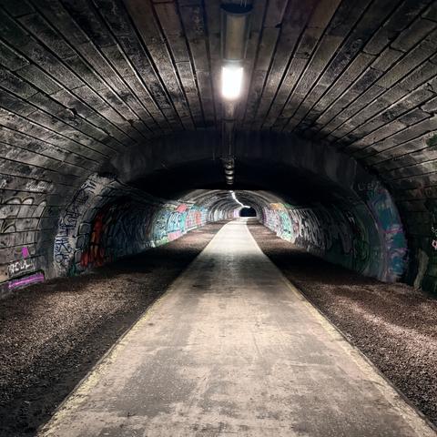 A graffiti-covered pedestrian tunnel.
