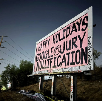 Graffiti on billboard that reads, "Happy Holidays Google Jury Nullification"